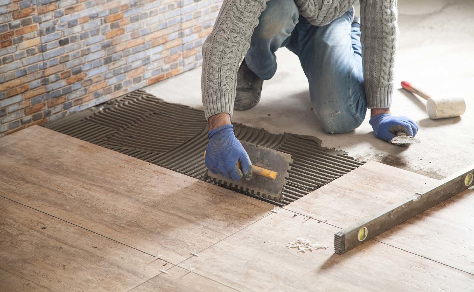 laying floor ceramic tile. renovating the floor